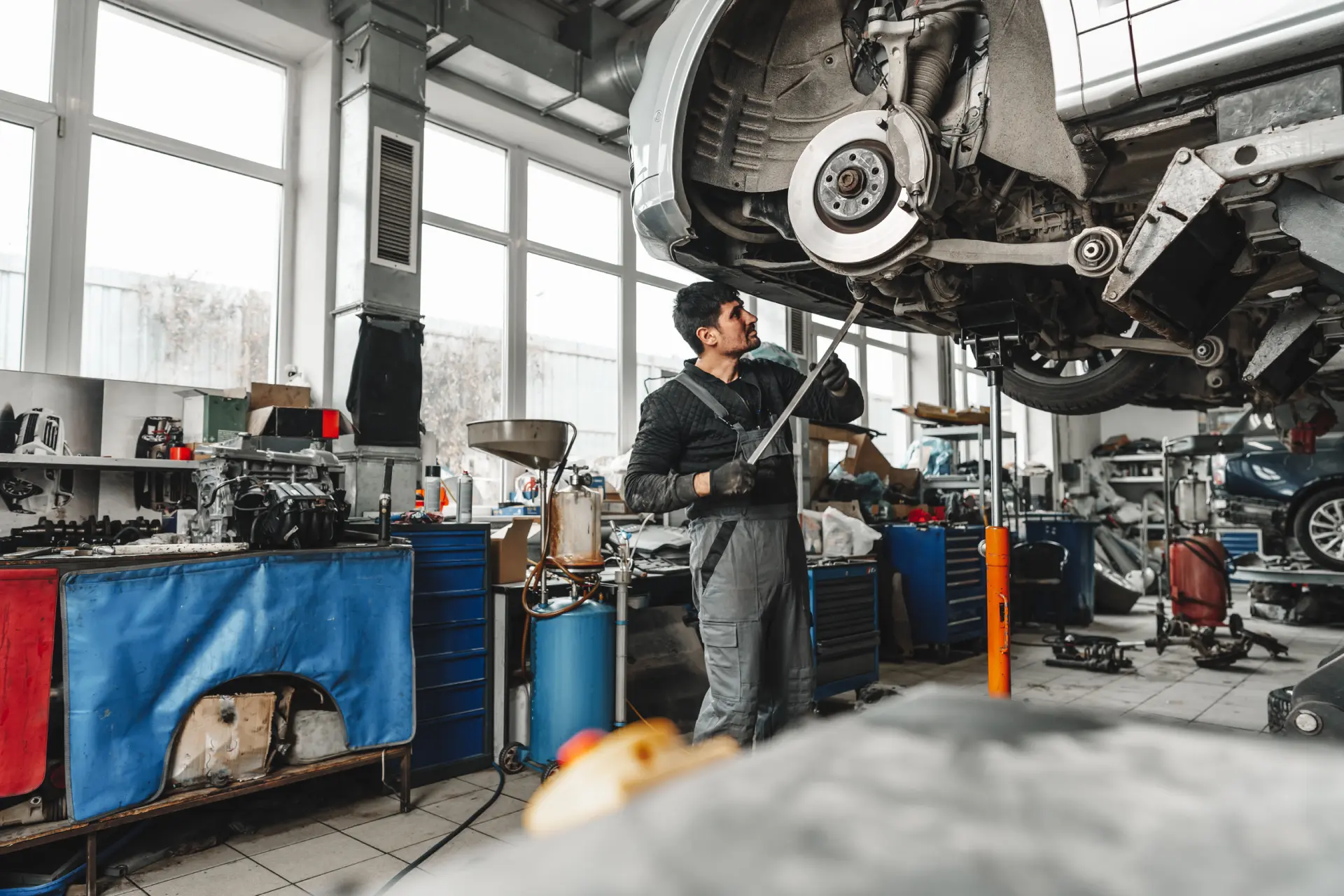 man-works-on-a-car-in-auto-repair-shop-2026-01-08-05-24-52-utc (1)